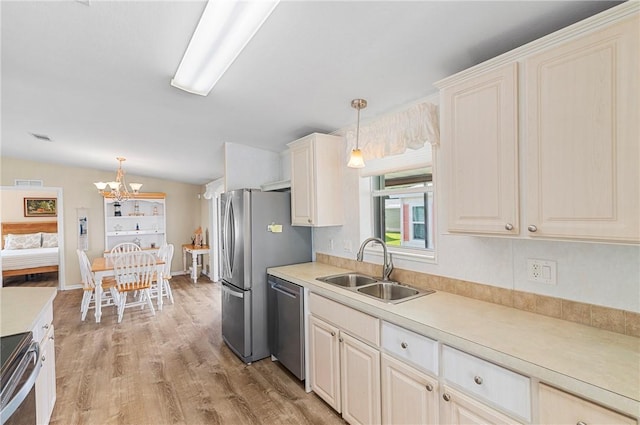 1218 Chipewa Dr, Sebastian, FL 32976 - kitchen featuring stainless steel appliances, a sink, a chandelier, light countertops, and plenty of natural light