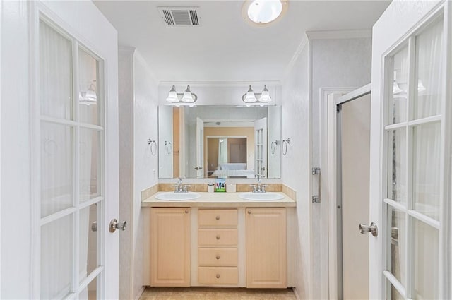 1218 Chipewa Dr, Sebastian, FL 32976 - bathroom featuring double vanity, french doors, a shower with door, and crown molding