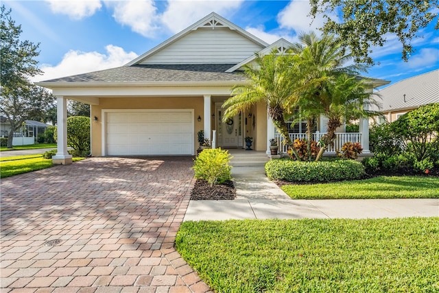 view of front of house with a front lawn, a garage, and a porch