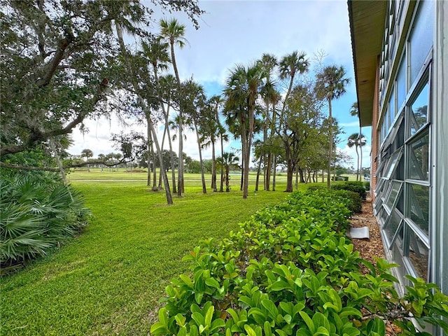 view of yard featuring glass enclosure