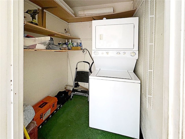 laundry room with stacked washing maching and dryer