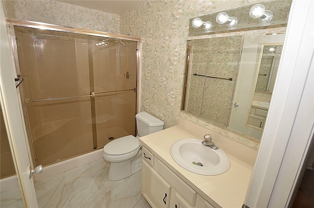 bathroom featuring a shower with shower door, vanity, and toilet