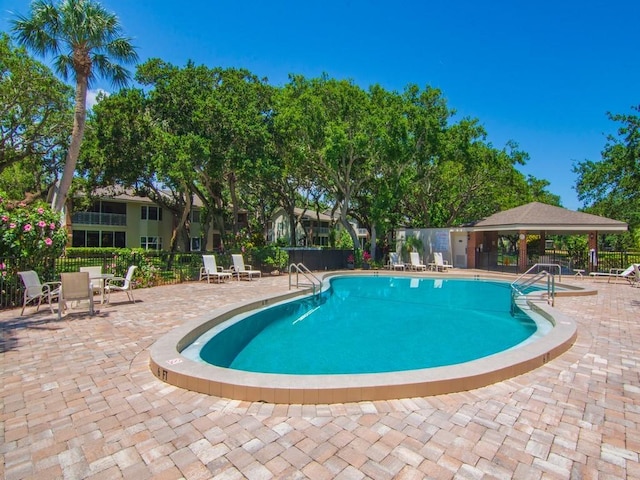 133 E Park Shores Cir Unit 8E, Vero Beach, FL 32963 - aerial view of property and surrounding area featuring nearby suburban area, a pool, and a large body of water