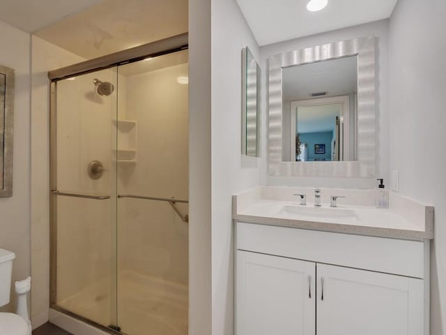 133 E Park Shores Cir Unit 8E, Vero Beach, FL 32963 - bathroom with toilet, a shower stall, and vanity