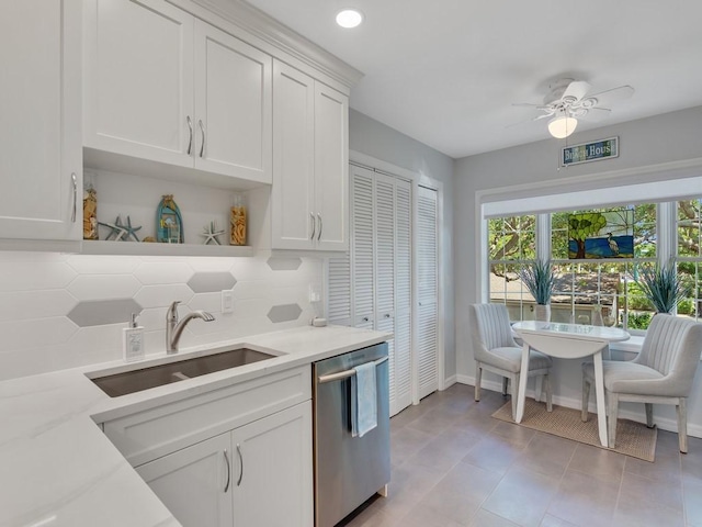 133 E Park Shores Cir Unit 8E, Vero Beach, FL 32963 - kitchen with stainless steel dishwasher, a sink, backsplash, white cabinets, and recessed lighting