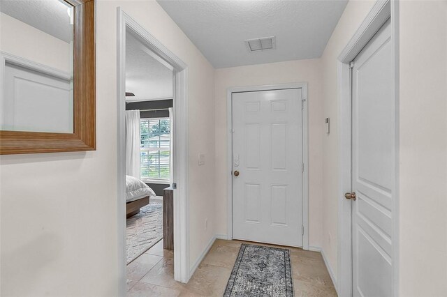 1360 18th Ave SW, Vero Beach, FL 32962 - foyer entrance featuring baseboards and a textured ceiling