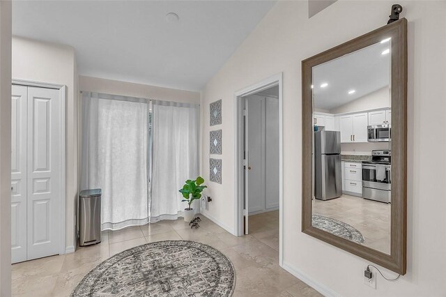 1360 18th Ave SW, Vero Beach, FL 32962 - corridor with lofted ceiling, baseboards, and light tile patterned floors