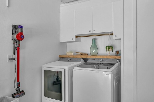 1360 18th Ave SW, Vero Beach, FL 32962 - washroom with cabinet space and washing machine and dryer