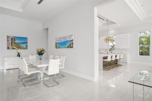 dining area featuring an inviting chandelier and sink