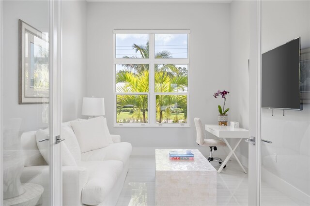 living area with plenty of natural light and french doors