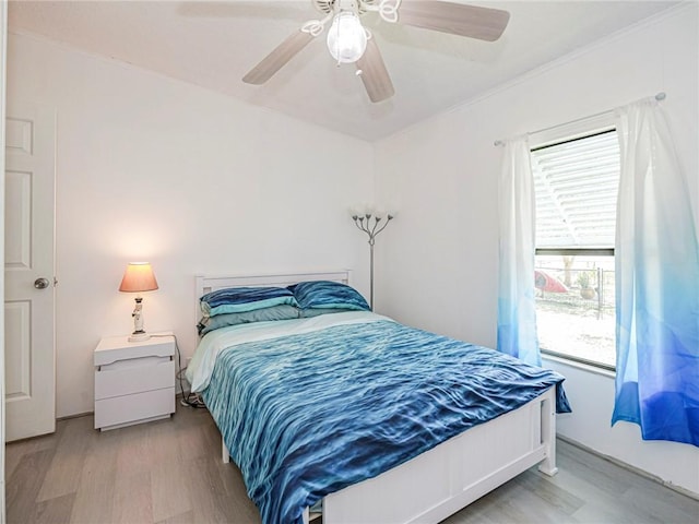 bedroom featuring light hardwood / wood-style floors and ceiling fan