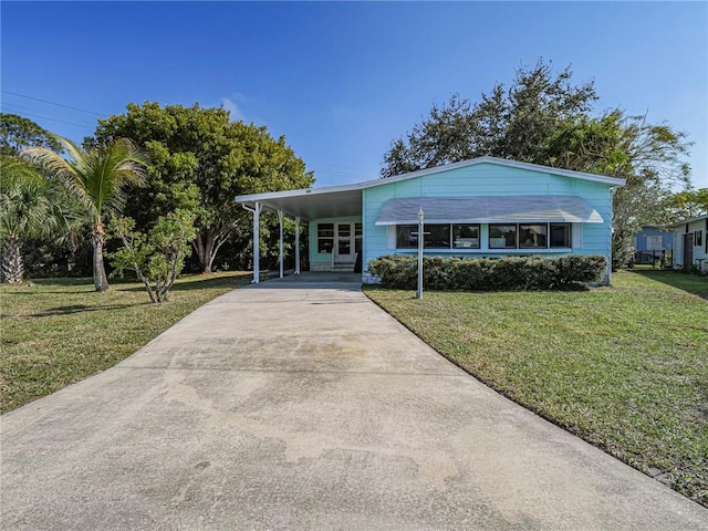 view of front facade with a carport and a front yard