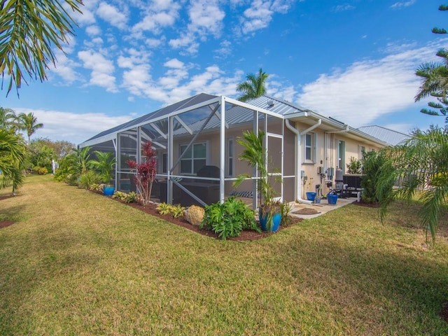 view of home's exterior with a lawn and a lanai