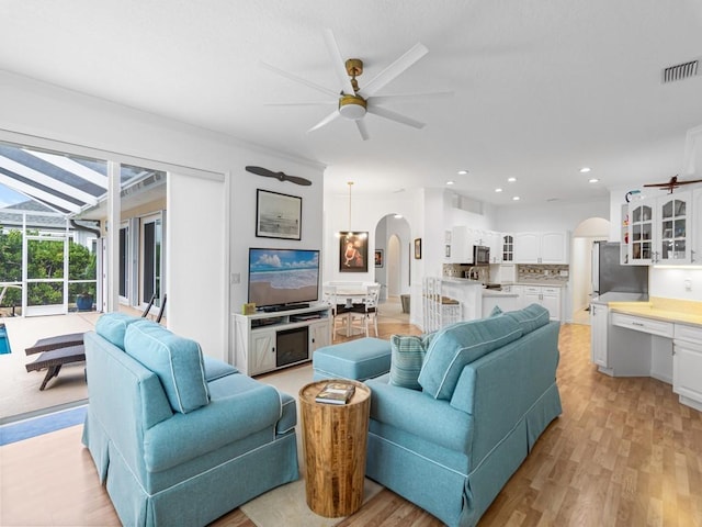 living room with ceiling fan and light hardwood / wood-style floors