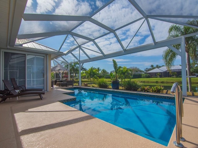 view of pool featuring glass enclosure and a patio area