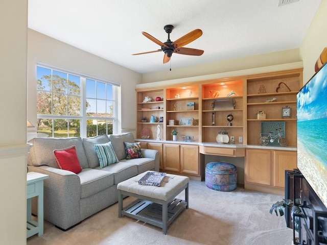 sitting room with light carpet and ceiling fan