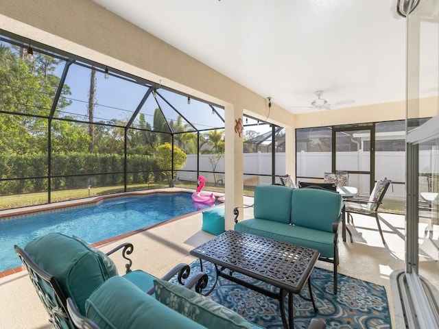 view of swimming pool with a lanai, a patio, ceiling fan, and outdoor lounge area