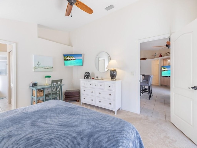 bedroom with ceiling fan, connected bathroom, and light tile patterned floors