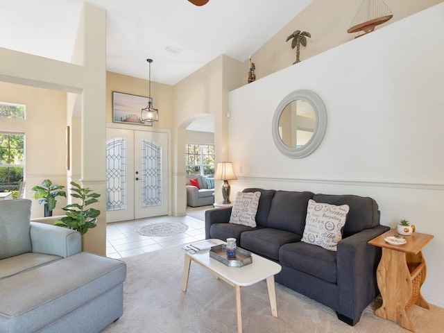 living room featuring french doors and light tile patterned flooring