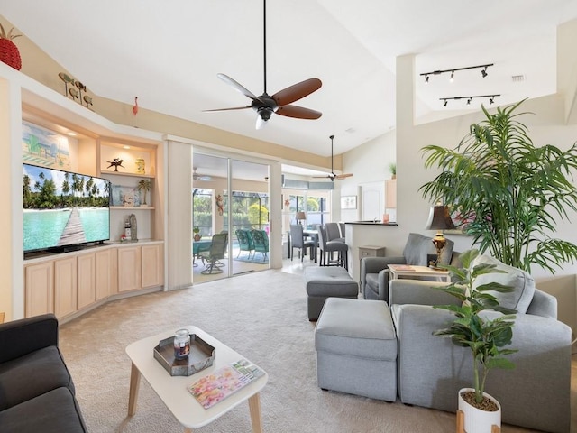 carpeted living room featuring rail lighting and ceiling fan