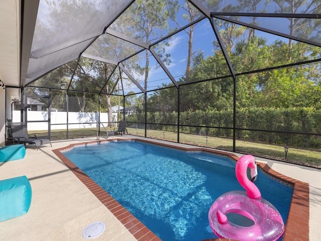 view of swimming pool with a lanai and a patio area