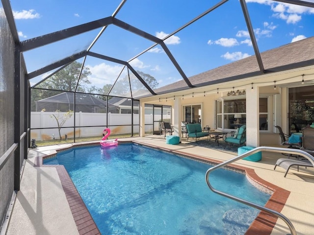 view of swimming pool with a patio and glass enclosure