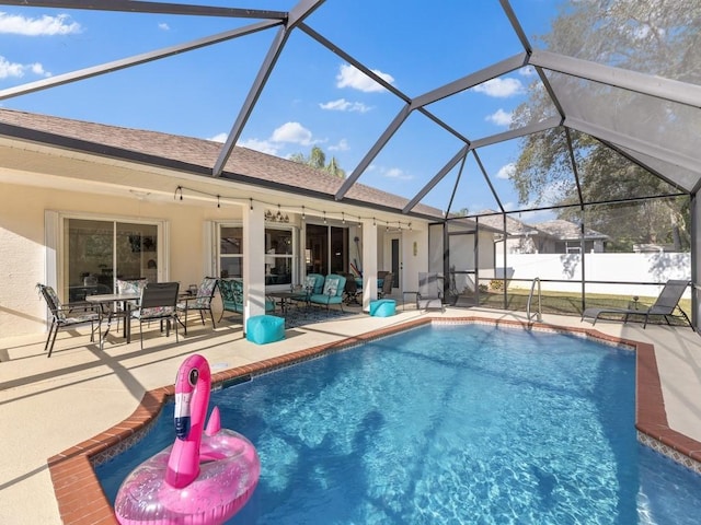 view of pool with a lanai and a patio