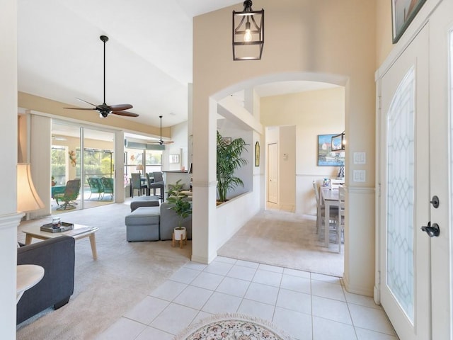 entryway featuring french doors, ceiling fan, and light colored carpet