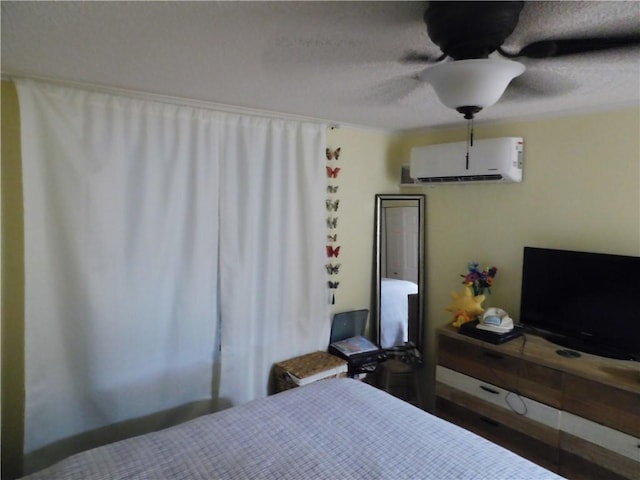 bedroom with a wall mounted air conditioner and ceiling fan