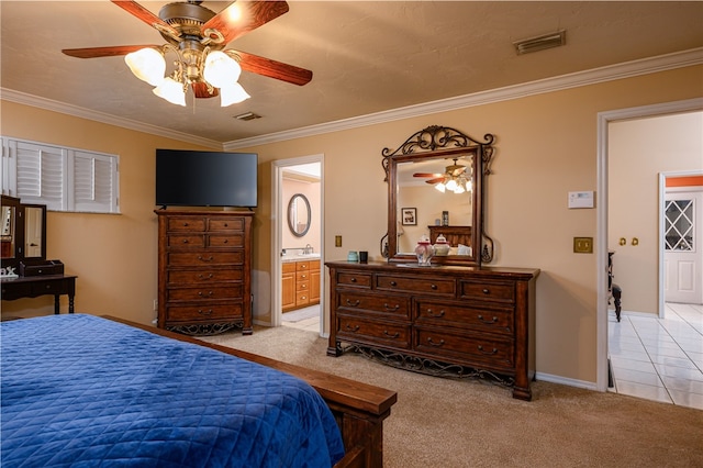 carpeted bedroom with sink, crown molding, ceiling fan, and ensuite bath