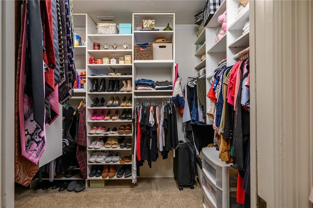 walk in closet with carpet floors