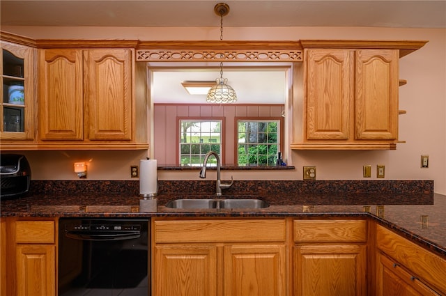 kitchen with dark stone counters, sink, decorative light fixtures, and black dishwasher