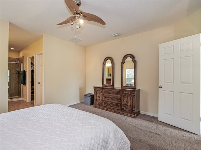 carpeted bedroom with ceiling fan, a closet, and a walk in closet