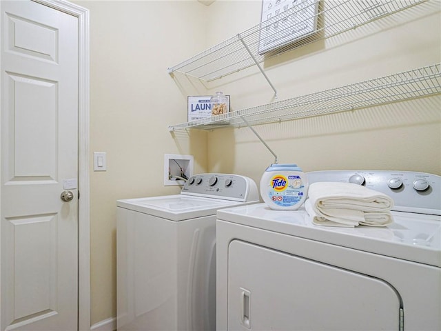 545 Valencia Cir SW, Vero Beach, FL 32968 - clothes washing area with independent washer and dryer