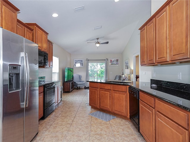 kitchen featuring black appliances, dark stone counters, ceiling fan, light tile patterned floors, and lofted ceiling