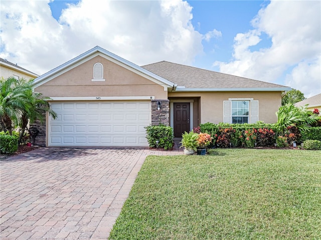 ranch-style house featuring a garage and a front lawn