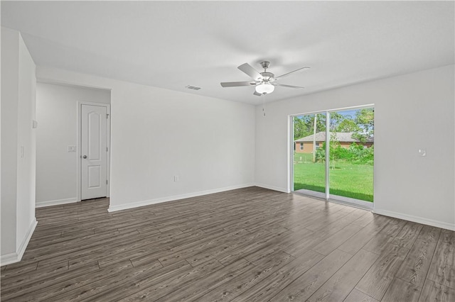 8725 98th Ct, Vero Beach, FL 32967 - empty room with dark wood-style flooring, a ceiling fan, and baseboards