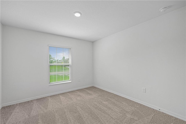 8725 98th Ct, Vero Beach, FL 32967 - carpeted empty room with baseboards and a smoke detector