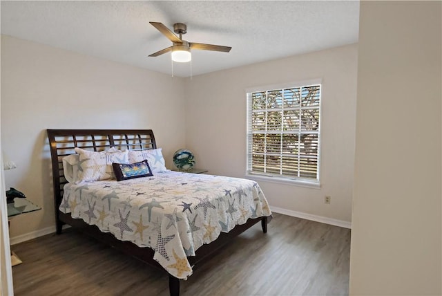 bedroom with a textured ceiling, dark hardwood / wood-style flooring, and ceiling fan