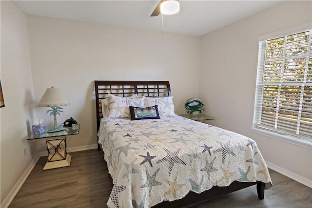 bedroom with ceiling fan and dark wood-type flooring