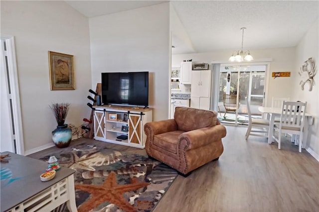 living room with an inviting chandelier and light wood-type flooring