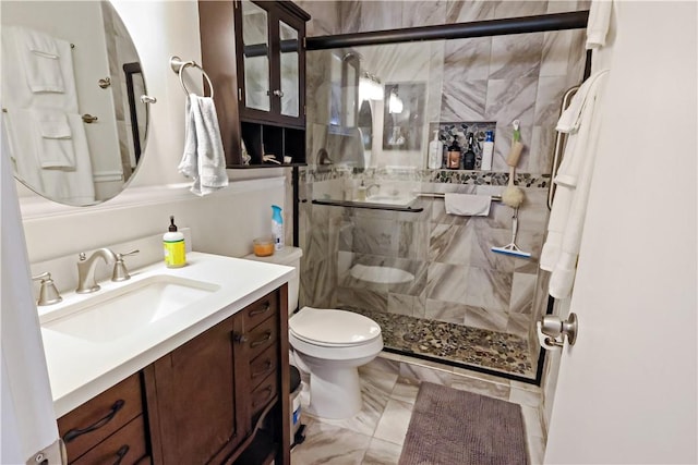 bathroom with vanity, an enclosed shower, and toilet