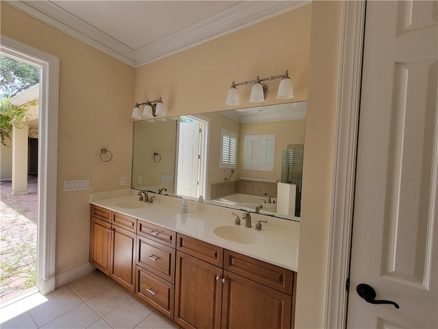 bathroom with tile patterned flooring, vanity, a bath, and ornamental molding