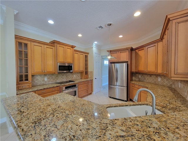 kitchen featuring light stone countertops, sink, decorative light fixtures, appliances with stainless steel finishes, and ornamental molding