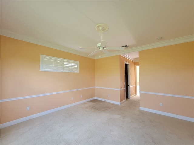 carpeted spare room featuring ceiling fan and ornamental molding