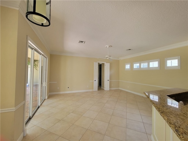 spare room with light tile patterned floors, ceiling fan, and crown molding