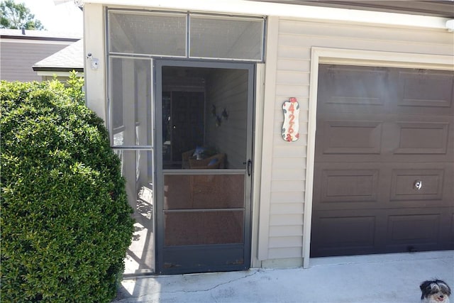 doorway to property featuring a garage