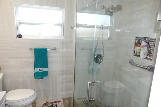 full bathroom featuring toilet, tile walls, and a shower stall
