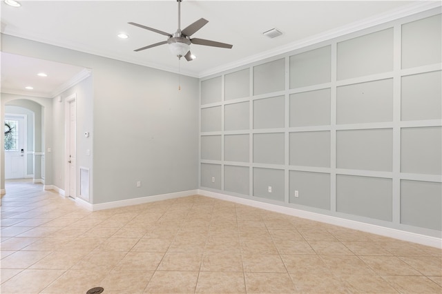 tiled empty room featuring ceiling fan and crown molding