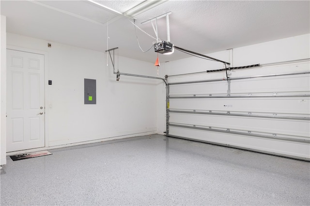 garage featuring electric panel and a garage door opener